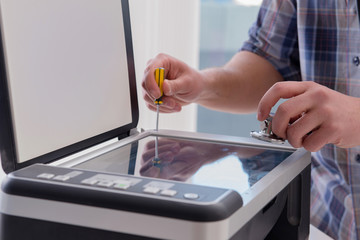Repairman repairing broken color printer