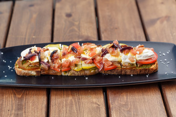 Bruschetta with cherry tomatoes, mozzarella.