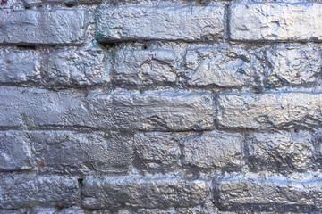 Silver glossy painted old brick wall background shine on a sun