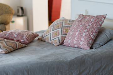 Made-up bed with blue bed linens and book of the hotel