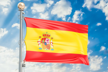 Spanish flag waving in blue cloudy sky, 3D rendering