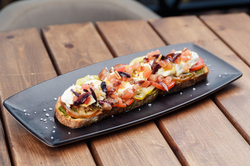 Bruschetta with cherry tomatoes, mozzarella.