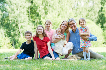 Big family in summer park outdoors.