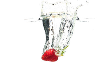 Strawberry falling in the water with splash, isolated on a white background