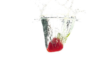 Strawberry falling in the water with splash, isolated on a white background