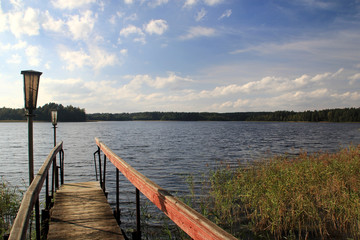 The wooden footbridge on the shore of the lake