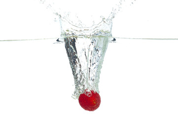 Strawberry falling in the water with splash, isolated on a white background