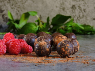 Chocolate balls raspberry mint. Gray background. Copy space.