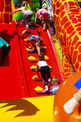 Children play on the inflatable children's playground in the city park. May 28, 2017.