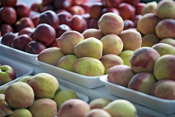 Peaches exposed in open-air market stall in Brazil