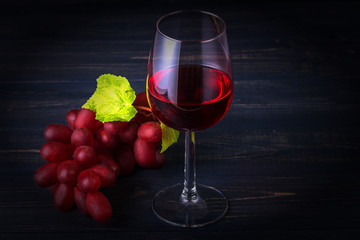 Glass of red wine and grapes
