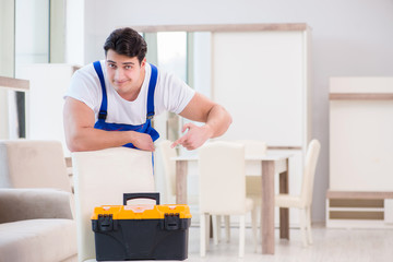 Obraz premium Furniture repairman working in store