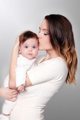 happy caring mother and her cute baby girl