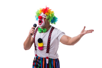 Funny clown with a microphone singing karaoke isolated on white 
