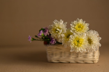 Colorful flowers in the wooden bucket