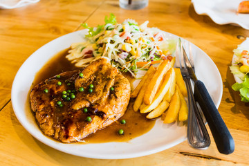 steak and sausage with salad
