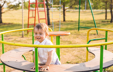 playful child with parents at the playground outdoor. Mom, dad and child.