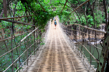 Suspension wooden and bamboo bridge for cross over stream river at Tad Pha Suam waterfalls