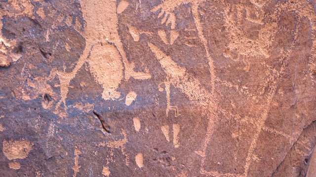 Panning view of Native American rock art on large rock near Moab Utah