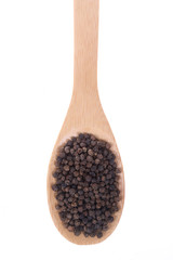 Black pepper on a bamboo spoon, isolated on white.