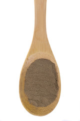 Dandelion powder on a bamboo spoon.