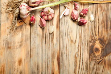 Fresh vegetables, garlic on a rustic wooden background. View from above.