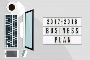 2017 to 2018 business plan on office table with computer, coffee and smartphone on wooden table