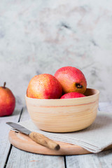 Fresh organic pears in wooden bowl on board on wooden table background. Healthy vegetarian food content. Copy space