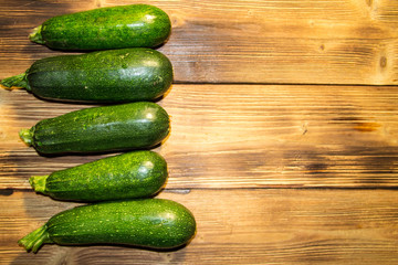 Fresh zucchini on wooden table. Top view