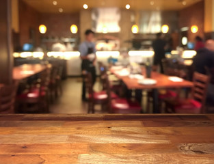 Empty wooden display table top front with blurred restaurant on background