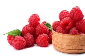ripe raspberries in wooden bowl isolated on white background close up