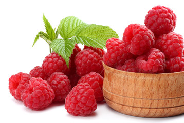 ripe raspberries in wooden bowl isolated on white background close up