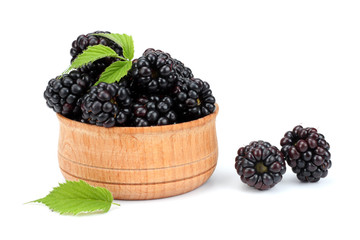 blackberries in wooden bowl isolated on white background