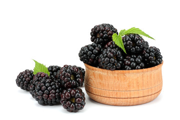 blackberries in wooden bowl isolated on white background