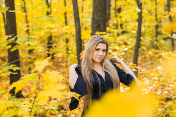 Portrait of beautiful girl as witch dressed in a dress with a hood. Halloween, carnival, holidays, autumn and people concept