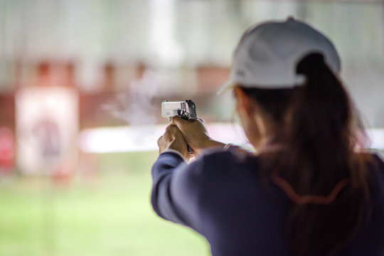 gun holding in hand of woman in practice shooting in martial arts for self defense in an emergency case