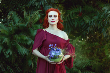 Beautiful woman is a shaman, in her hands she is holding magic.