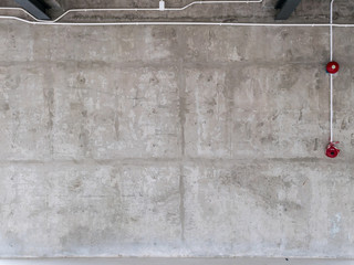 industrial concrete wall with electric wire and fire alarm
