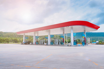Obraz premium Gas fuel station with clouds in the sky and sun light