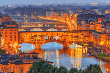 Naklejka premium Ponte Vecchio is a bridge in Florence, located at the narrowest point of the Arno River, almost opposite the Uffizi Gallery. Night time.