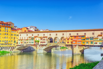 Fototapeta na wymiar Ponte Vecchio is a bridge in Florence, located at the narrowest point of the Arno River, almost opposite the Uffizi Gallery.Italy.