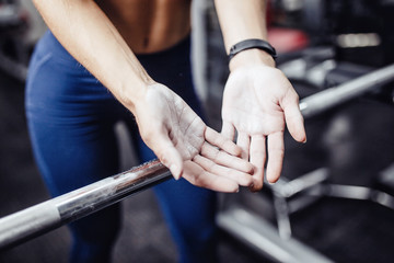 Close-up of girl's hand in pumice stone, talc. Texture of lines, prints, preparation for training with a barbell.