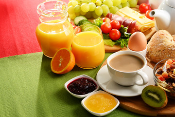 Breakfast served with coffee, orange juice, egg and fruits