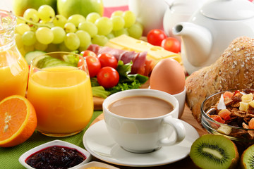 Breakfast served with coffee, orange juice, egg and fruits