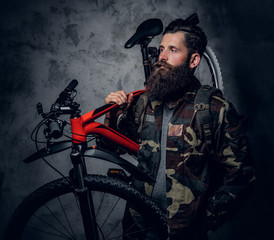 Obraz na płótnie Canvas A man holds mountain bicycle.