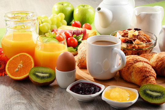 Breakfast served with coffee, orange juice, egg and fruits