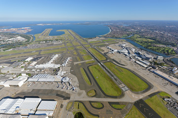 Sydney Airport, looking south-west over the Domestic and International Terminals towards Botany Bay