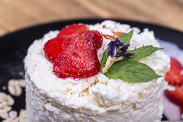 Cottage cheese and red strawberry on the table