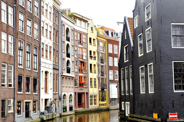 Fototapeta na wymiar Scenic view of colorful buildings and canal in Amsterdam, Holland