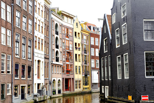 Scenic view of colorful buildings and canal in Amsterdam, Holland © tanialerro